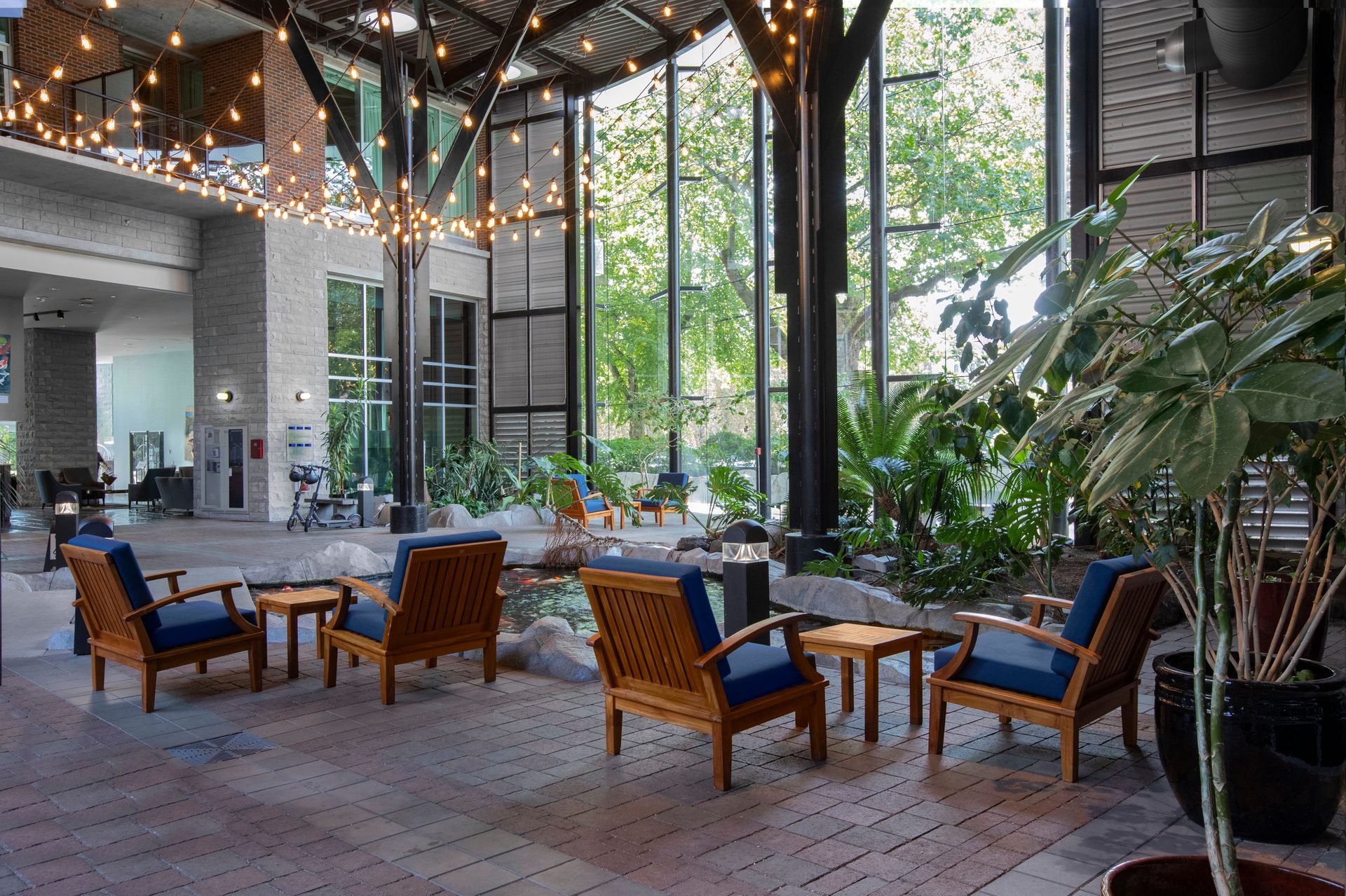 The Parkside Hotel atrium with string lights and lush greenery